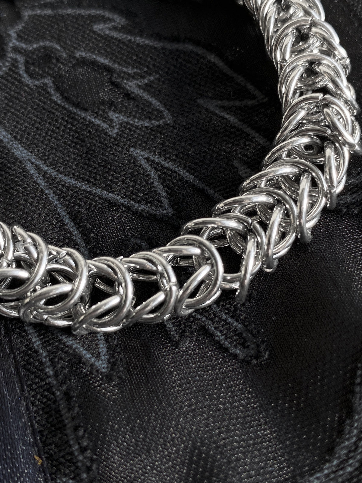 Arum sculptural chainmail bracelet showing interwoven stainless steel links